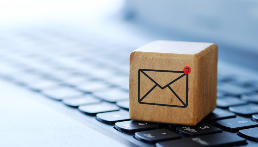 dés en bois avec logo d email sur un clavier